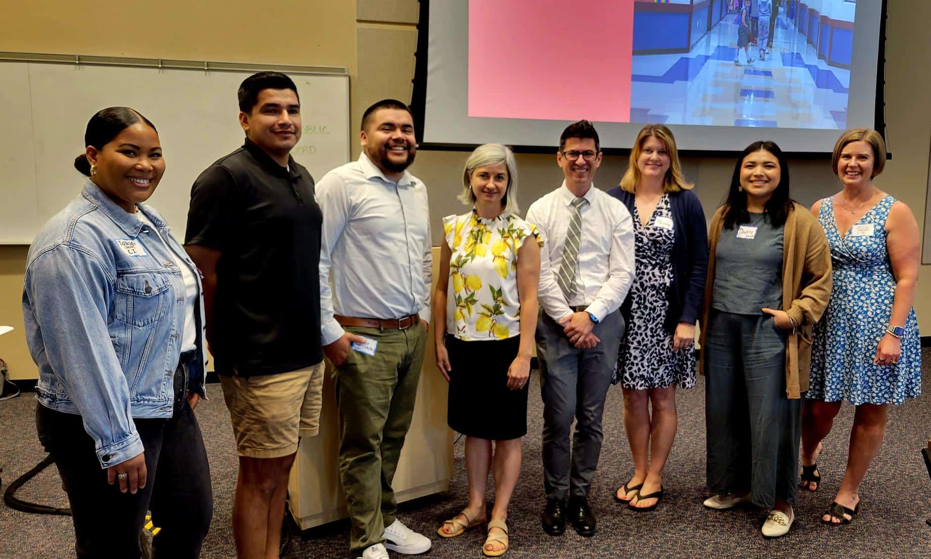 This image shows a smiling group of CI Staff members standing in a line.