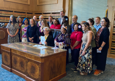 This is an image of the Governor signing bills into law at the Oregon Capitol surrounded by early childhood advocates